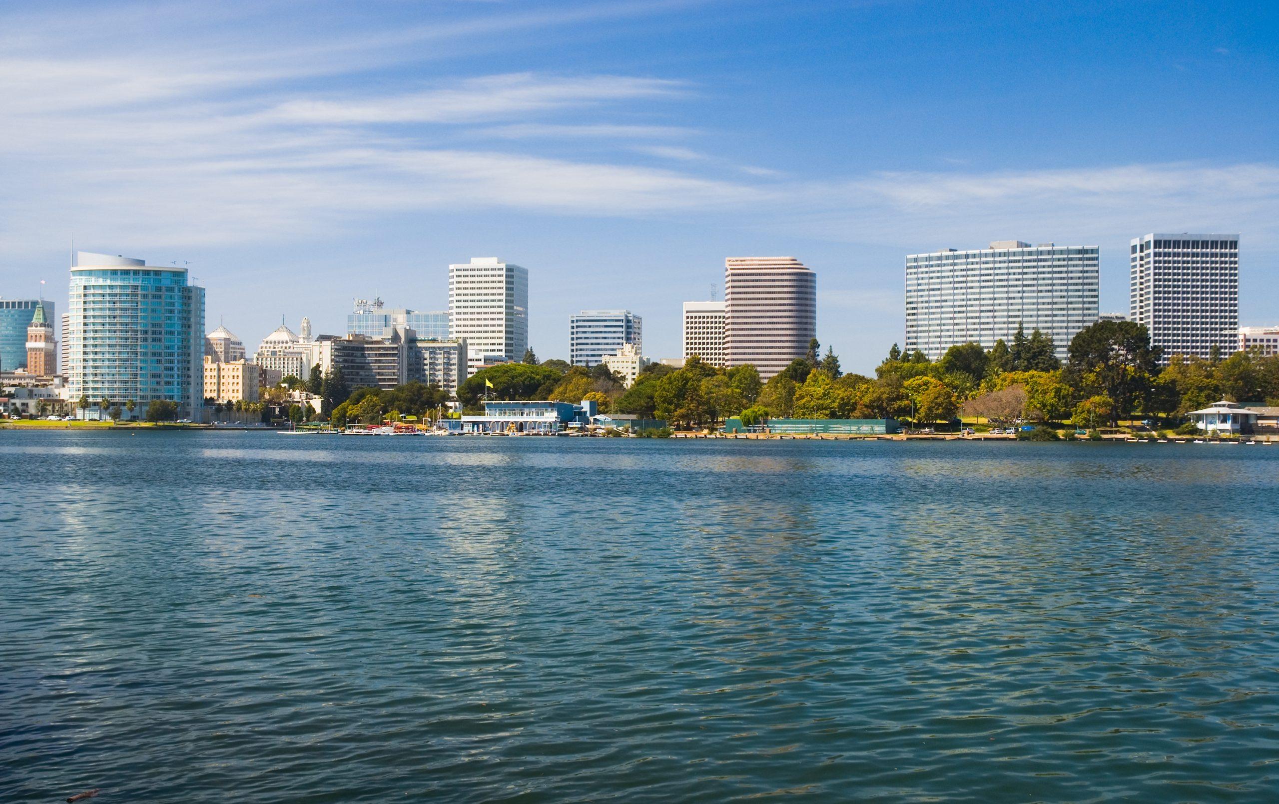 Oakland Downtown skyline with Lake Merritt in the foreground.