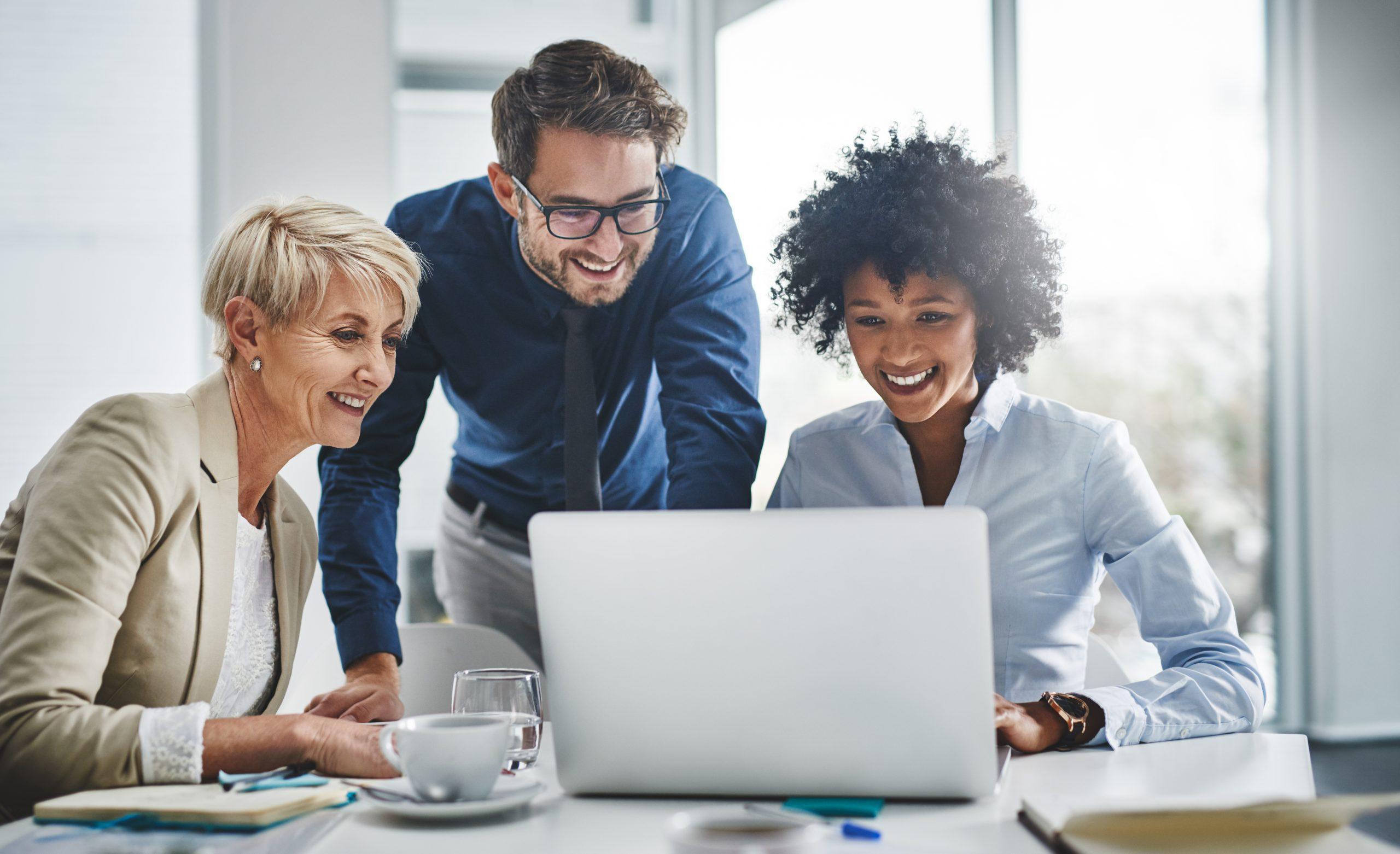 Shot of a group of businesspeople working together on a laptop